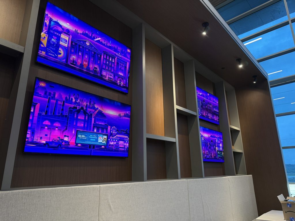Wall-mounted displays arranged above booth seating.